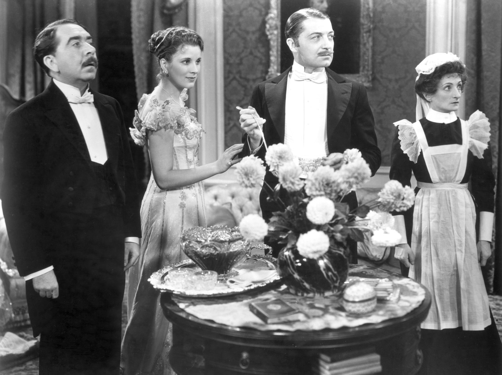 from left to right: Herbert Mundin as “Alfred Bridges”, Diana Wynward as “Jane Marryot”, Clive Brook as “Robert Marryot”, and Una OConnor as “Ellen Bridges”