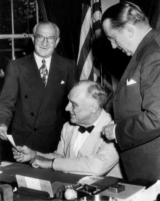 Nicholas M. Schenk (far left) hands check to FDR.